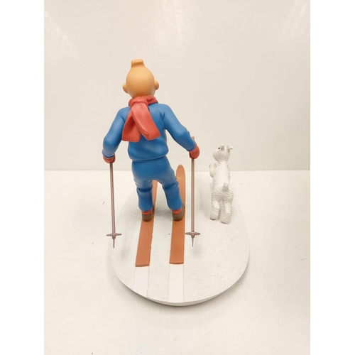 587 - A Tin Tin Herge Moulinsart model of Tin Tin skiing with Snowy. Good condition with box and comes wit... 