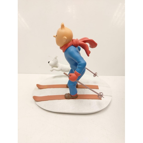 587 - A Tin Tin Herge Moulinsart model of Tin Tin skiing with Snowy. Good condition with box and comes wit... 