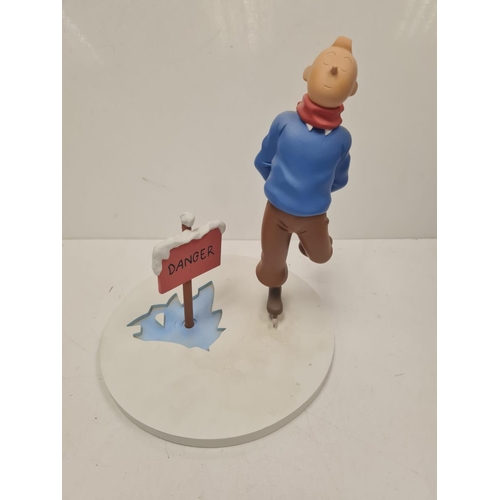 506 - A Tin Tin Herge Moulinsart model of Tin Tin avoiding broken ice. Good condition and comes with the b... 