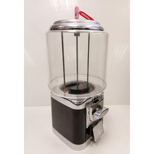 513 - A classic Gumball machine. Coin operated, locking key on top. Clear plastic with black plastic/metal... 