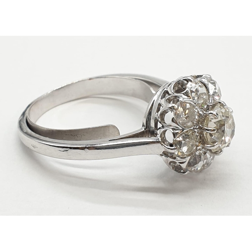 63 - Platinum diamond cluster ring in floral design, weight 5.58g and size P with over 3ct diamonds.