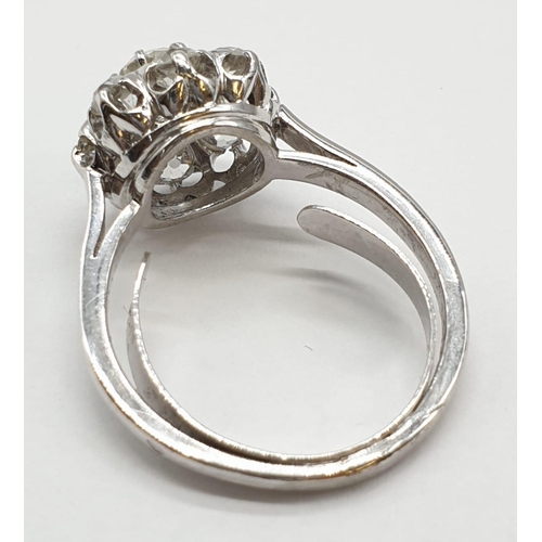 63 - Platinum diamond cluster ring in floral design, weight 5.58g and size P with over 3ct diamonds.