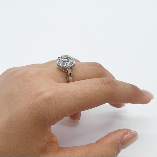 63 - Platinum diamond cluster ring in floral design, weight 5.58g and size P with over 3ct diamonds.