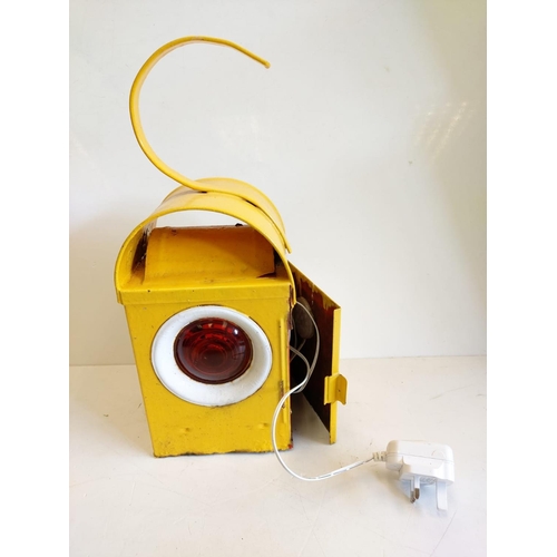 280 - A roadside, road works warming lamp. In working order - plug operated; with amber lens. 13cm x H43cm