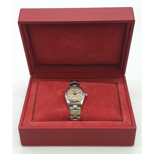 61 - Ladies Rolex Oyster Perpetual with champagne colour face and steel bracelet, 26mm case, with origina... 