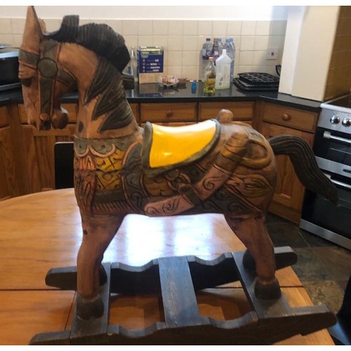 1002 - A vintage hand carved and hand painted children's wooden rocking horse. 90cm high x 80cm wide.