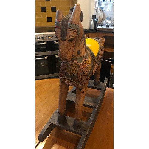 1002 - A vintage hand carved and hand painted children's wooden rocking horse. 90cm high x 80cm wide.