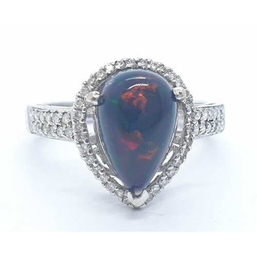 1000 - A 18ct white gold and diamond ring with black opal centre stone. Weight 3.6g, Size N.