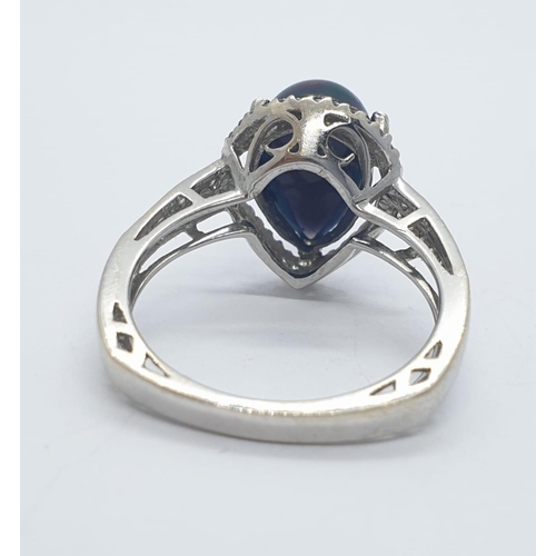 1000 - A 18ct white gold and diamond ring with black opal centre stone. Weight 3.6g, Size N.