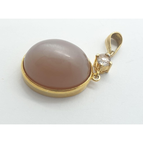 1003 - An 18ct gold plus rose diamond and moonstone pendant. 5.9g in weight.