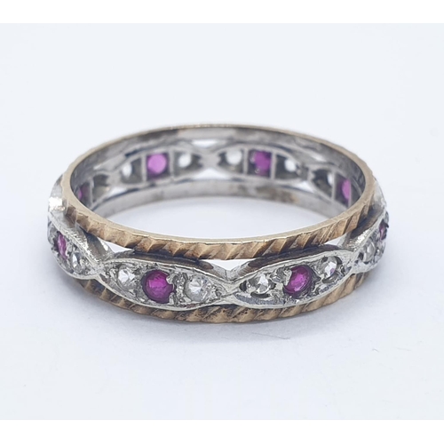 1009 - 9ct ruby and white sapphire eternity ring. 2.6g in weight. Size  O.