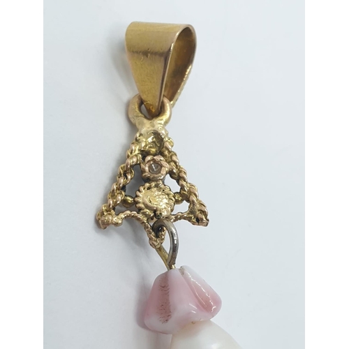 1001 - A 18ct rose gold diamond ruby and teardrop pearl pendant. 5.2g in weight, 4.5cm drop.