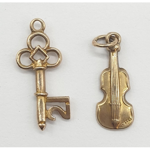 324 - Two 9ct gold pendants. '21' Key and Violin. 2cm in length. Weight 1.23g