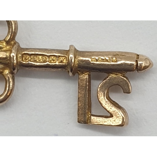 324 - Two 9ct gold pendants. '21' Key and Violin. 2cm in length. Weight 1.23g