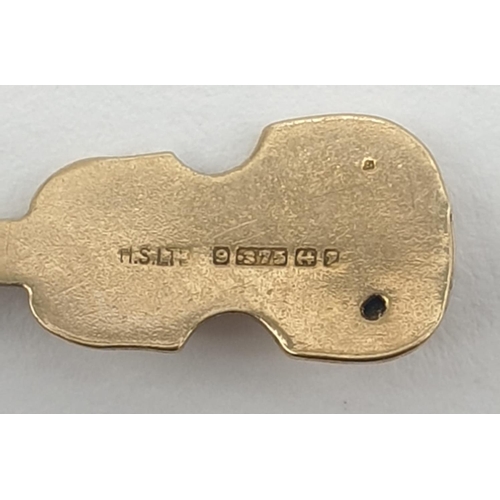 324 - Two 9ct gold pendants. '21' Key and Violin. 2cm in length. Weight 1.23g