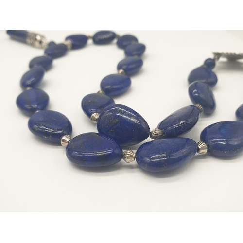 103 - A tear drop shaped lapis lazuli necklace and earrings with long obelisks. Necklace length: 54cm, ear... 