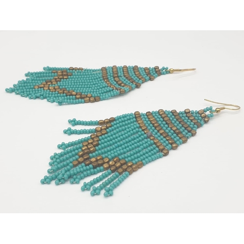 117 - A vintage, bluish-green, North African beadwork necklace and earrings set in a presentation box. Nec... 