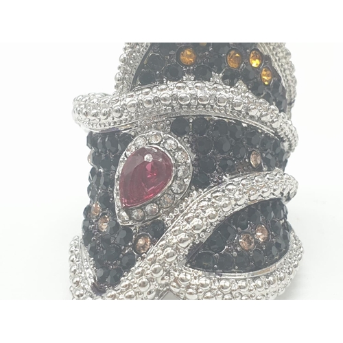 127 - A hand cut, lead crystal, trinket box, revealing an unusual ring of large proportions with black sap... 