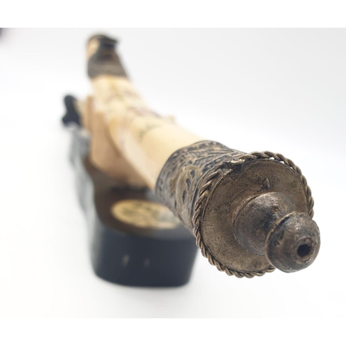 85 - An antique Chinese opium pipe, made of water buffalo bone,  on a custom  made base made of wood and ... 