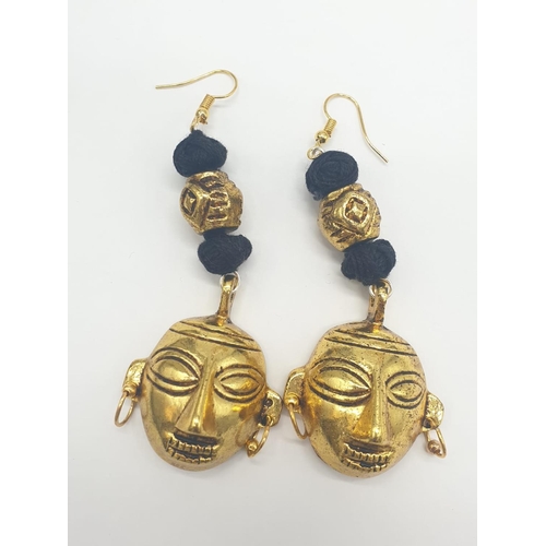 92 - An original west African (Benin style) necklace and earrings set with gilded metal tribal masks. Ori... 