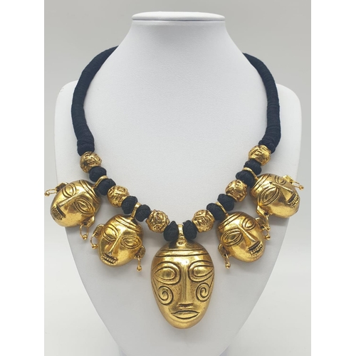 92 - An original west African (Benin style) necklace and earrings set with gilded metal tribal masks. Ori... 