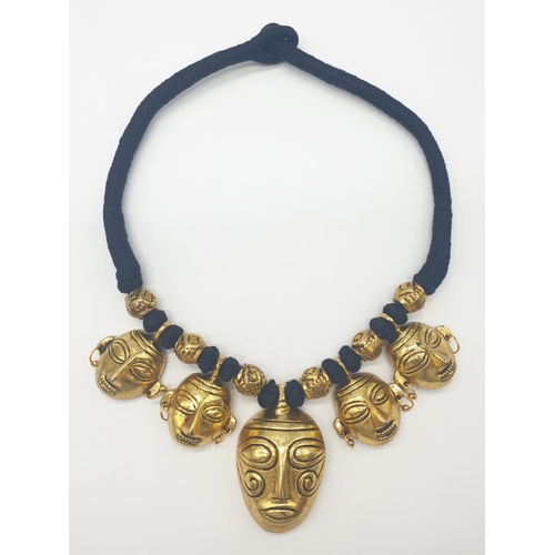 92 - An original west African (Benin style) necklace and earrings set with gilded metal tribal masks. Ori... 