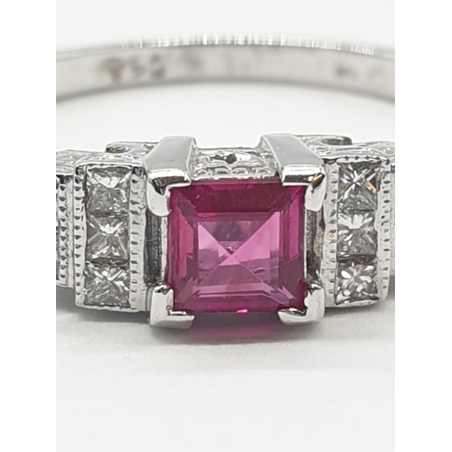 113 - An art deco style ladies 18ct white gold diamond and ruby (emerald cut) ring. Size N.0.3ct ruby. Tot... 