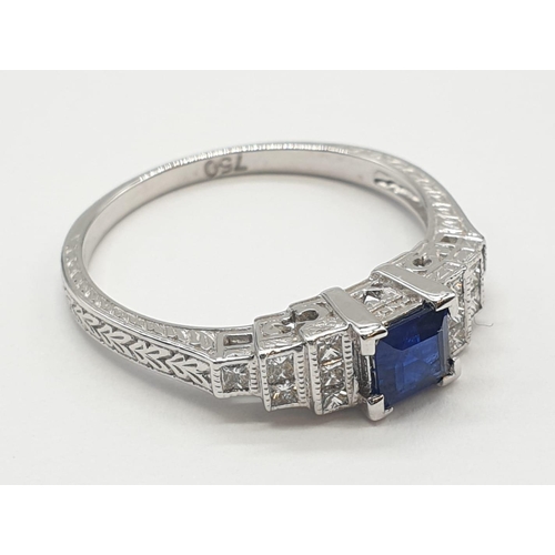 16 - An Art-deco  style ladies 18ct white gold diamond and sapphire (emerald cut) ring. Szie N. 0.3ct sap... 