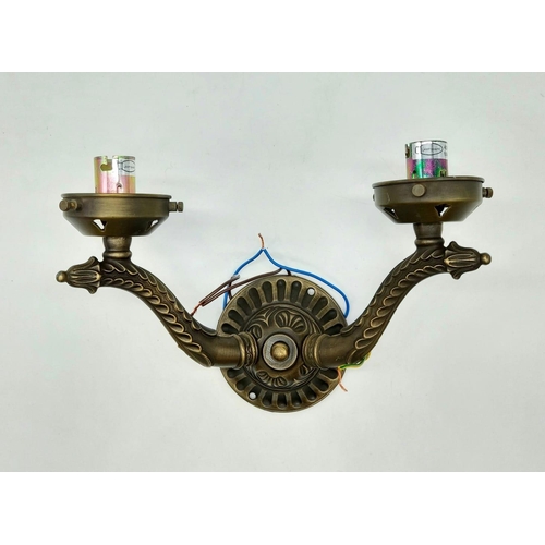 465 - A pair of well decorated gilded wall lights with brass effect. Unused, as new.28 x 25cm