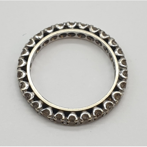 393 - 9ct white gold eternity ring. 3.2g, size P.