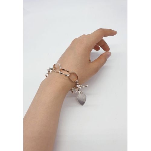 478 - Large link silver bracelet with silver heart. 19g, approx 20cm