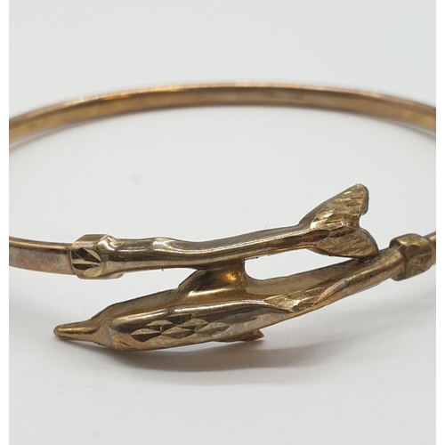 245 - A Harrods Vintage 9ct Gold Bangle with Dolphin design clasp. Comes in box, 4.16g. 6cm diameter (8cm ... 