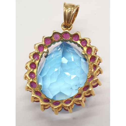 124 - Topaz and ruby in 14ct gold pendant, weight 8g