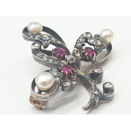 145 - Aspreys diamond and ruby brooch embellished with pearls, weight 7.5g and 35mm long approx