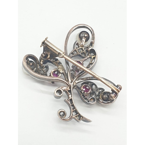 145 - Aspreys diamond and ruby brooch embellished with pearls, weight 7.5g and 35mm long approx