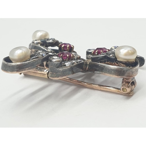 145 - Aspreys diamond and ruby brooch embellished with pearls, weight 7.5g and 35mm long approx