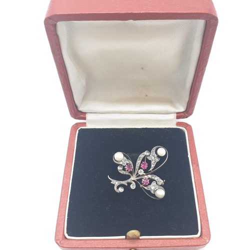 145 - Aspreys diamond and ruby brooch embellished with pearls, weight 7.5g and 35mm long approx