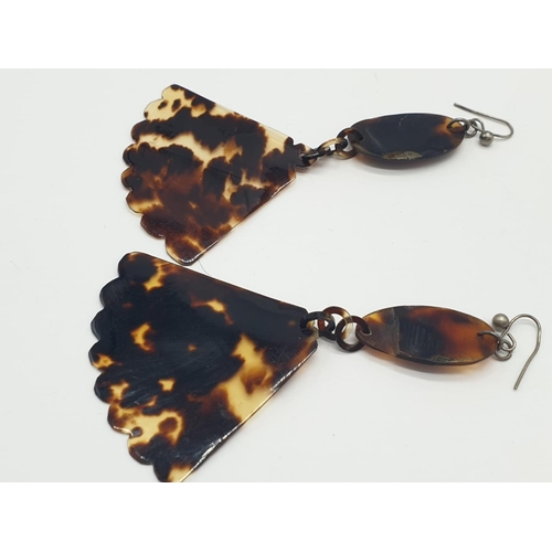 210 - Tortoiseshell and silver earrings. 4.2g in weight. 8cm drop.