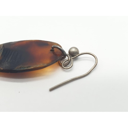 210 - Tortoiseshell and silver earrings. 4.2g in weight. 8cm drop.