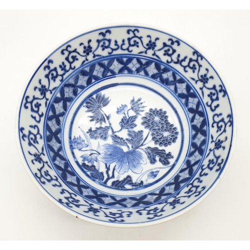 253 - An early Chinese SIGNED porcelain bowl hand painted blue and white floral design, 20cm diameter