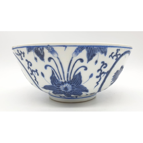 253 - An early Chinese SIGNED porcelain bowl hand painted blue and white floral design, 20cm diameter