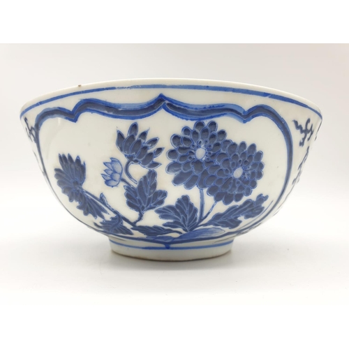 253 - An early Chinese SIGNED porcelain bowl hand painted blue and white floral design, 20cm diameter