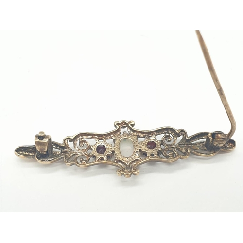 276 - 9ct gold opal and garnet bar brooch, weight 2.5g and 4cm long approx