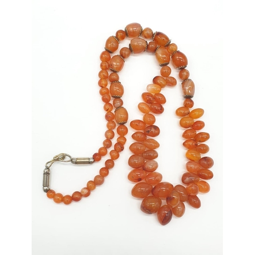 291 - Interesting amber coloured necklace. 85.1g in weight. 52cm in length.