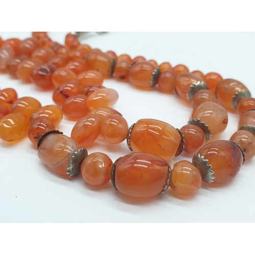 291 - Interesting amber coloured necklace. 85.1g in weight. 52cm in length.