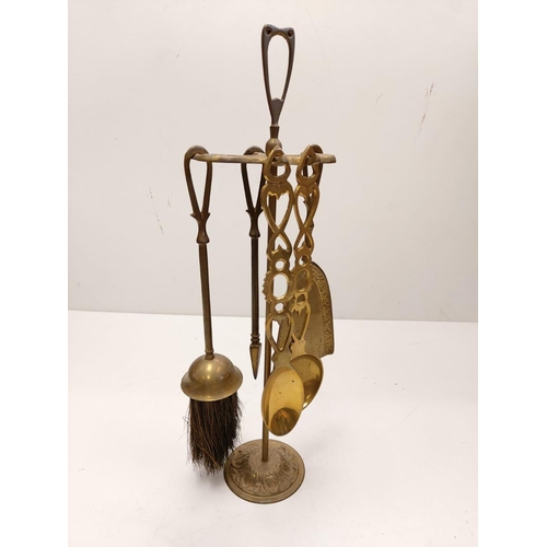 838 - A bronze selection of vintage fireside utensils including decorated brass bellows.