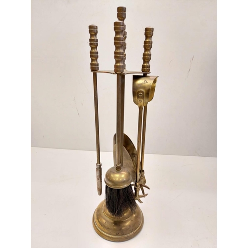 838 - A bronze selection of vintage fireside utensils including decorated brass bellows.