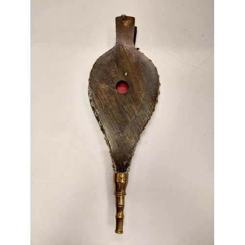 838 - A bronze selection of vintage fireside utensils including decorated brass bellows.