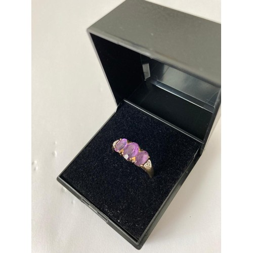 182 - 9ct gold and amethyst ring. Having three faceted and amethysts to top and diamond points to shoulder... 