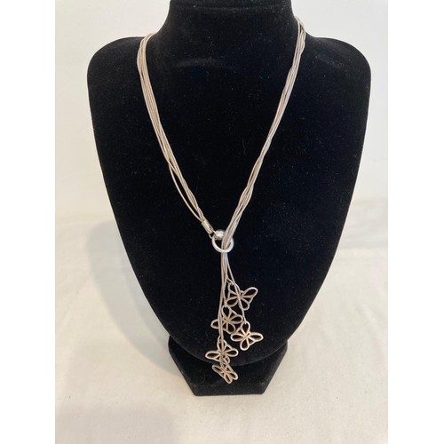 673 - Silver five strand necklace, each strand having a butterfly pendant. Pull through style to front wit... 